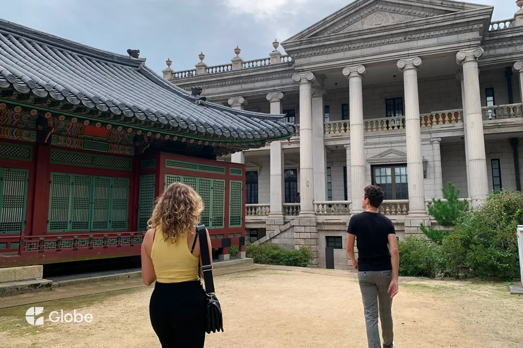 Two friends walking together on a trip, exploring a historic courtyard