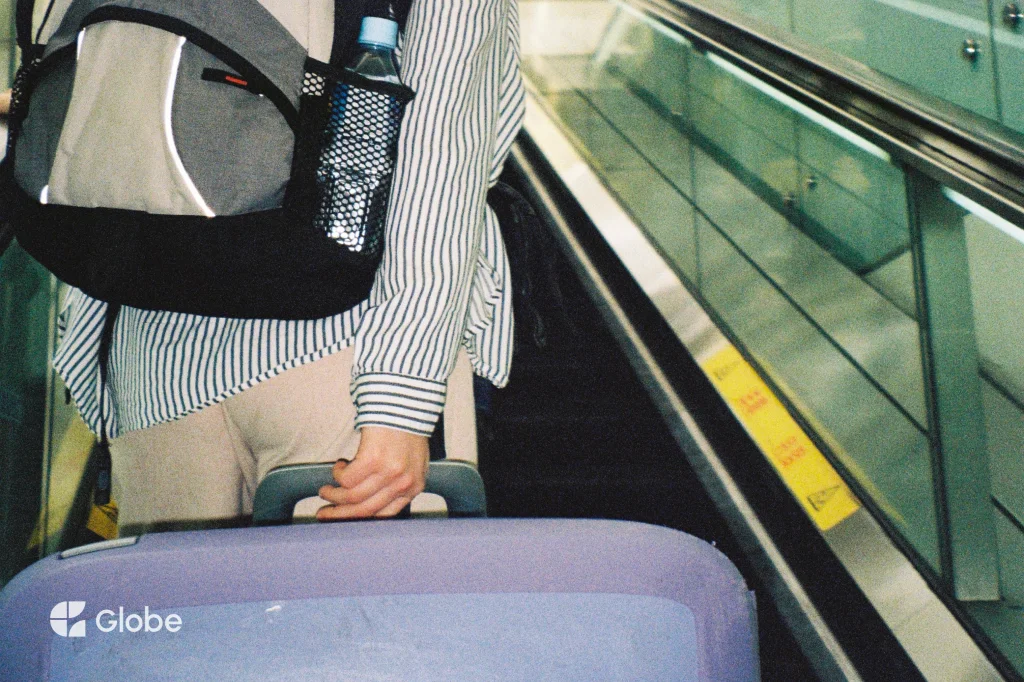 Traveller pulling a suitcase through an airport on the way to a group trip