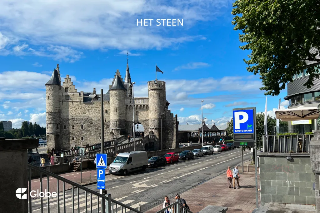 Antwerp's medieval stone fortress with round turrets, seen from across the street on a sunny day