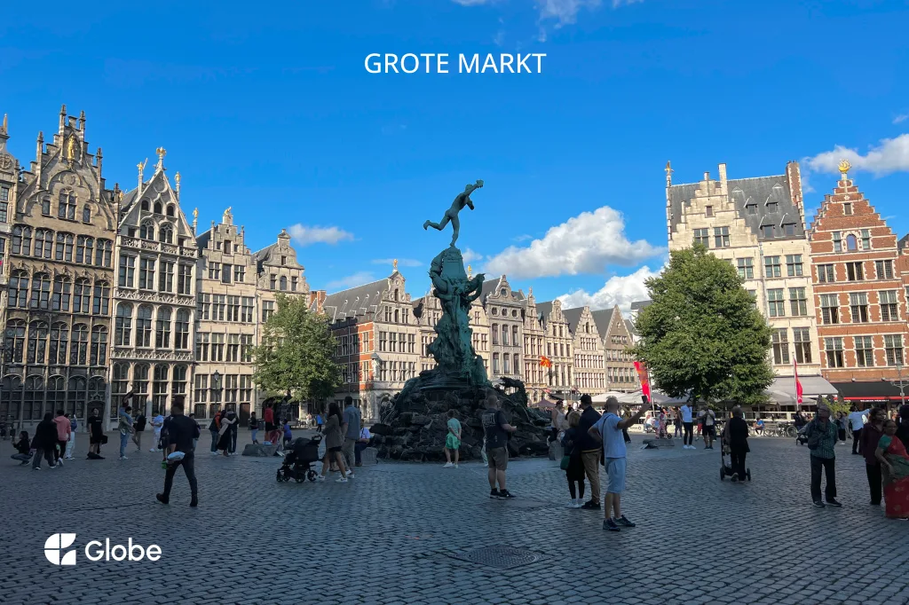 Grote Markt square in Antwerp, lined with historic guild houses and a fountain statue, filled with visitors