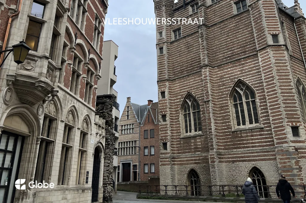 A view down Vleeshouwersstraat toward the Vleeshuis, with its Gothic arched windows and brick facade