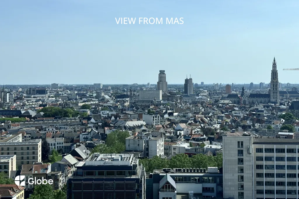 Panoramic view of Antwerp's rooftops and skyline from the top of MAS, with the Cathedral spire visible in the distance